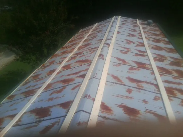 Rusted metal roof panels with new wood purlins before replacement — Storm Damage Roof Repair in Olivebridge by Roofing Brothers