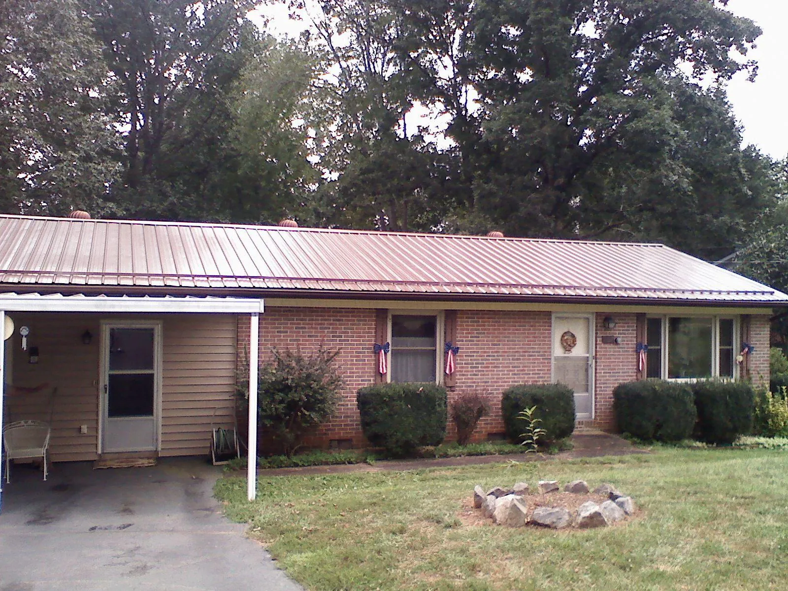 Bronze metal roof and carport on a brick ranch home — Roof Repair work by our crew in Olivebridge